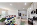 Bright kitchen featuring stainless steel appliances, granite countertops, and a breakfast bar at 339 Cherryhill Ln, Woodstock, GA 30188
