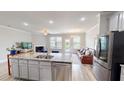 Kitchen island with stainless steel dishwasher offering views of fireplace and living room at 339 Cherryhill Ln, Woodstock, GA 30188
