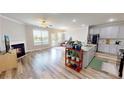 Open concept living area boasts a fireplace, kitchen island, and access to the outdoors at 339 Cherryhill Ln, Woodstock, GA 30188