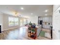 Open concept living and dining featuring granite countertops, stainless appliances, and sleek flooring at 339 Cherryhill Ln, Woodstock, GA 30188