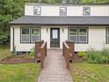 Close up of the house featuring a wooden ramp leading to the front door, with fresh landscaping at 172 White Rose Ln, Temple, GA 30179