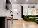 Bright and modern living room with hardwood floors and comfortable green sectional sofa at 2200 Glendale Dr, Atlanta, GA 30032