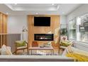 Cozy living room features modern fireplace, decorative ladder, stylish furniture, and light-filled window at 1505 Ezra Church Nw Dr, Atlanta, GA 30314