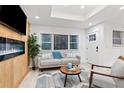 Bright living room with electric fireplace, light wood floors and neutral decor at 1566 Ezra Church Nw Dr, Atlanta, GA 30314
