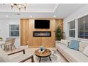 Bright living room with decorative fireplace and mantle, light wood floors and neutral decor at 1566 Ezra Church Nw Dr, Atlanta, GA 30314