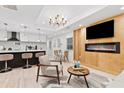 Open-concept living area featuring a modern fireplace, kitchen, dining and hardwood floors at 1566 Ezra Church Nw Dr, Atlanta, GA 30314
