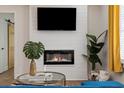 A cozy fireplace with a television above, alongside a comfortable seating area with bright window accents at 749 Bonnie Brae Sw Ave, Atlanta, GA 30310