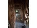 Hallway showcasing the exposed framing, leading to more rooms in the property at 1713 Cahoon Sw St, Atlanta, GA 30310