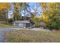 Quaint single-Gathering home with a driveway, showcasing a well-maintained exterior and natural surroundings at 5861 Community Rd, Mableton, GA 30126