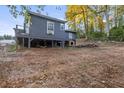 View of the elevated rear of a house, showing the deck and the surrounding landscape in a rural setting at 5861 Community Rd, Mableton, GA 30126