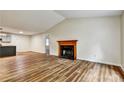 Bright living room featuring a wood-burning fireplace and laminate floors at 6211 Ward Rd, Union City, GA 30291