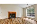 Cozy living room with a fireplace and large window offering ample natural light at 6211 Ward Rd, Union City, GA 30291