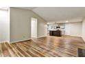 Open-concept living room with laminate floors, connecting to the kitchen at 6211 Ward Rd, Union City, GA 30291