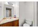 Cozy bathroom showcasing a charming vanity, toilet, and a well-lit mirror at 2323 Wingfoot Pl, Decatur, GA 30035