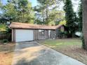 A single story home with brown siding and a one car garage at 33 Drew Ct, Jonesboro, GA 30238
