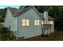 Exterior view of the back of the house showing light gray siding and a small deck with stairs at 504 Iris Way, Villa Rica, GA 30180