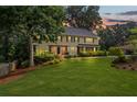 Charming two-story home with a manicured lawn and beautiful landscaping enhancing its curb appeal at 1416 Vernon Ridge Close, Dunwoody, GA 30338