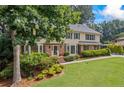 Beautiful two-story home with manicured lawn, mature trees, and meticulously maintained landscaping at 1416 Vernon Ridge Close, Dunwoody, GA 30338