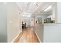 Open view from the kitchen area towards the dining room with wood vinyl flooring at 1968 Drennon Ave, Austell, GA 30106
