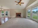 Spacious living room featuring a brick fireplace and large windows providing ample natural light at 110 Silverthorne Dr, Douglasville, GA 30134