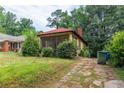 Exterior of a single-story home with a red roof and a screened front porch at 969 Byron Sw Dr, Atlanta, GA 30310