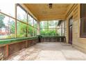 Enclosed front porch featuring a concrete floor, wood trim, and screened windows at 969 Byron Sw Dr, Atlanta, GA 30310