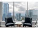 Living room featuring modern furnishings and floor-to-ceiling windows showcasing city skyline at 3338 Peachtree Ne Rd # 3406, Atlanta, GA 30326