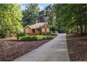 Brick home featuring a long driveway and a beautifully landscaped front yard at 2525 Fairview Dr, Cumming, GA 30041