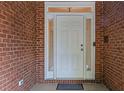 Front door framed by sidelights and brick, providing a secure entrance at 2525 Fairview Dr, Cumming, GA 30041