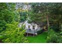 House surrounded by lush greenery, featuring a deck and an inviting atmosphere at 6719 Sunset Valley Cir, Rex, GA 30273