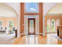 Bright foyer with hardwood floors, arched doorways and transom window above the front door at 1350 Whitley Rd, Dacula, GA 30019