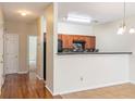Open kitchen area with wooden cabinets and a breakfast bar, adjacent to a staircase at 2284 Nicole Dr, Hampton, GA 30228