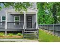 Inviting gray home with a charming front porch and steps leading to the entrance at 935 Pelham Nw St, Atlanta, GA 30318
