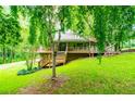 Lovely exterior view showcasing wooden decking and a green lawn at 1775 Whooping Creek Rd, Carrollton, GA 30116