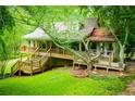 Attractive home featuring a multi-level wooden deck and lush surroundings at 1775 Whooping Creek Rd, Carrollton, GA 30116