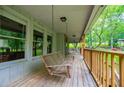 Inviting covered porch with a wooden swing, offering a relaxing outdoor space at 1775 Whooping Creek Rd, Carrollton, GA 30116