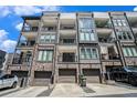 Modern townhome exterior featuring brick accents, private balconies, and convenient garage parking at 383 Pratt Se Dr # 503, Atlanta, GA 30315