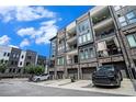 Modern townhome exterior featuring brick accents, private balconies, and convenient garage parking at 383 Pratt Se Dr # 503, Atlanta, GA 30315