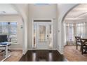 Inviting foyer featuring dark hardwood floors, a bright windowed front door, and high ceilings at 6918 Diamond Dr, Rex, GA 30273