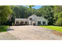 Charming two-story home with a basketball hoop, black shutters and a well-manicured lawn at 12550 Hutcheson Ferry Rd, Palmetto, GA 30268