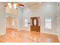 Inviting living room with large windows, hardwood floors, and a view into the dining area at 155 Skyview Dr, Social Circle, GA 30025