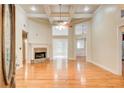 Spacious living room featuring a fireplace, high ceilings, and gleaming hardwood floors at 155 Skyview Dr, Social Circle, GA 30025