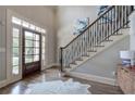 Elegant foyer with hardwood floors, staircase, and a front door with sidelights allowing plenty of natural light at 16 Cambridge Way, Cartersville, GA 30121