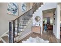 Bright foyer with hardwood floors, elegant staircase, and stylish decor, offering a warm welcome into the home at 16 Cambridge Way, Cartersville, GA 30121