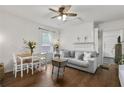 Comfortable living room with hardwood floors, a cozy gray sofa, and a fireplace, creating a relaxing atmosphere at 818 Virgil Ne St, Atlanta, GA 30307