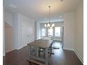 Dining room next to kitchen features sleek hardwood floors and a modern light fixture at 2163 Wiggins Walk, Atlanta, GA 30316