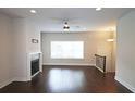 Open-concept living room featuring beautiful hardwood floors and a cozy fireplace at 2163 Wiggins Walk, Atlanta, GA 30316