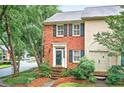 Charming townhome featuring brick facade, complemented by mature landscaping and a welcoming entrance at 2197 Spring Walk Ct, Atlanta, GA 30341