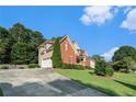 Side view of home with brick and siding, attached garage, and driveway at 1290 Mount Mckinley Dr, Grayson, GA 30017