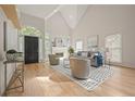 Bright living room with hardwood floors, high ceilings, a fireplace and neutral-toned furniture at 1902 Connemara Dr, Atlanta, GA 30341